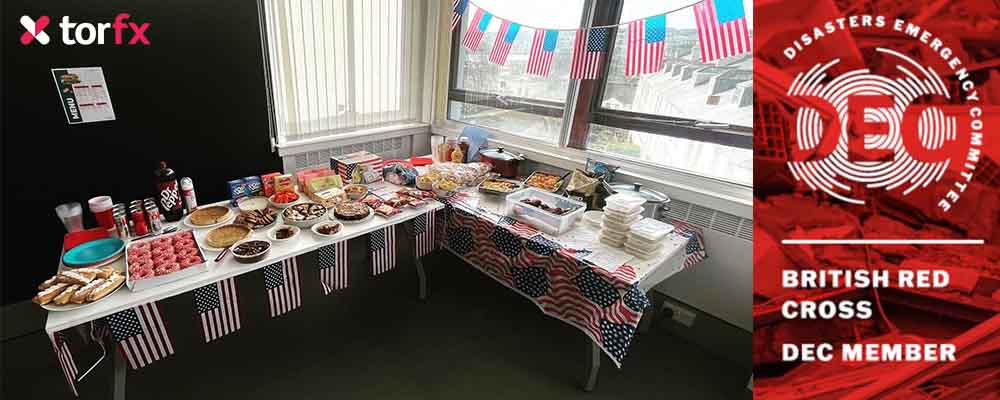 TorFX USA Celebration Day buffet with selection of American foods. TorFX Logo and the British Red Cross DEC ember appeal logo.