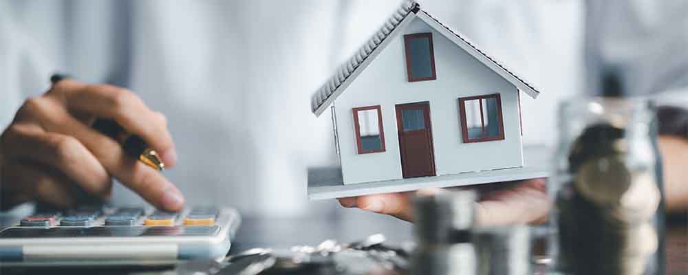 Saving investment home with loan finance money business concept. Investment banking finance for residential real estate business. Stack coins with model house for investment loans.Cash for taxes.