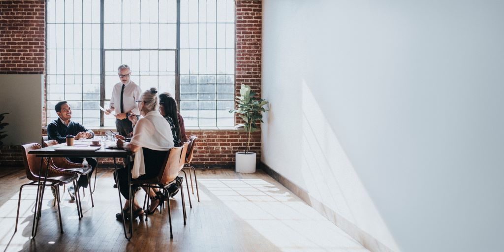 People having a work meeting in a spacious office.